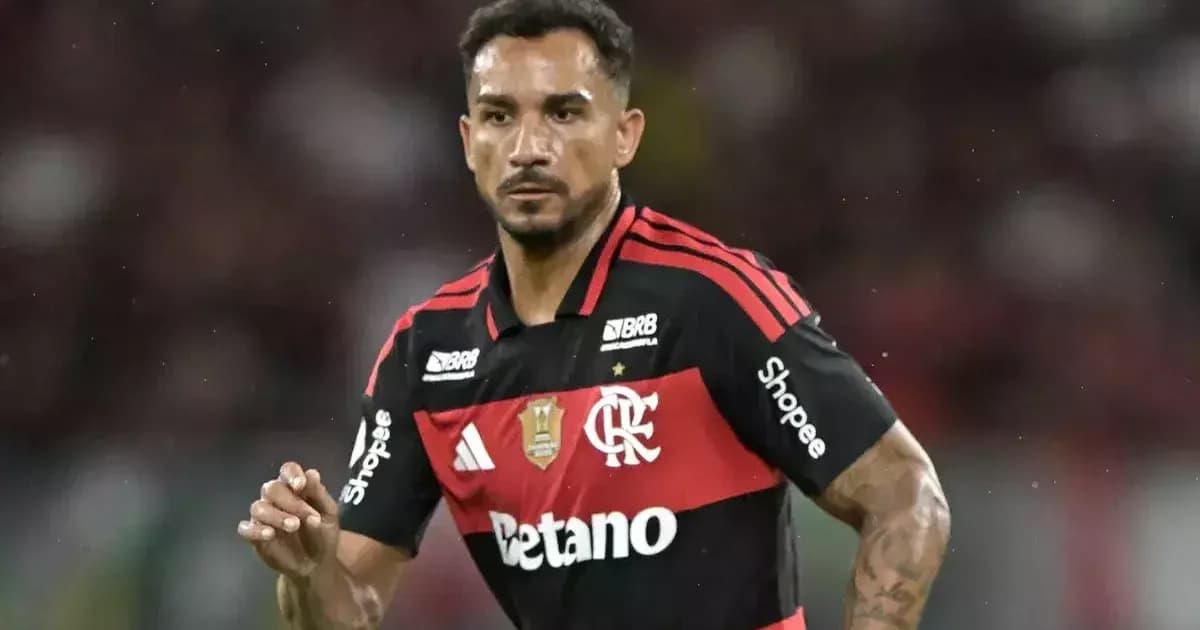 Ilustração editorial: zagueiro veterano celebra renovação até 2027 em estádio com bandeiras vermelho e preto e torcida.