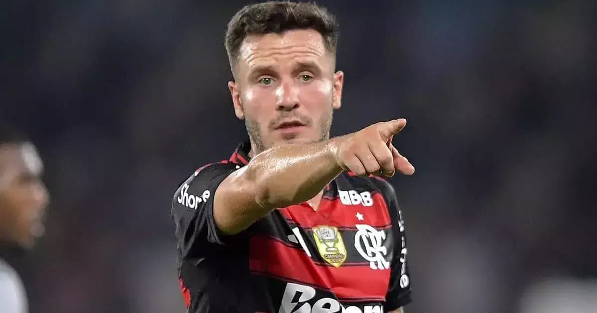 Estádio semi vazio em tons vermelho e preto, pequeno treino, equipe médica e calendário da Data FIFA até 6 de outubro.