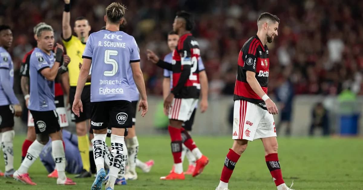 Estádio em La Plata com banco vazio e camisa rubro-negra, cartão vermelho no ar, clima tenso antes da semifinal da Libertadores.