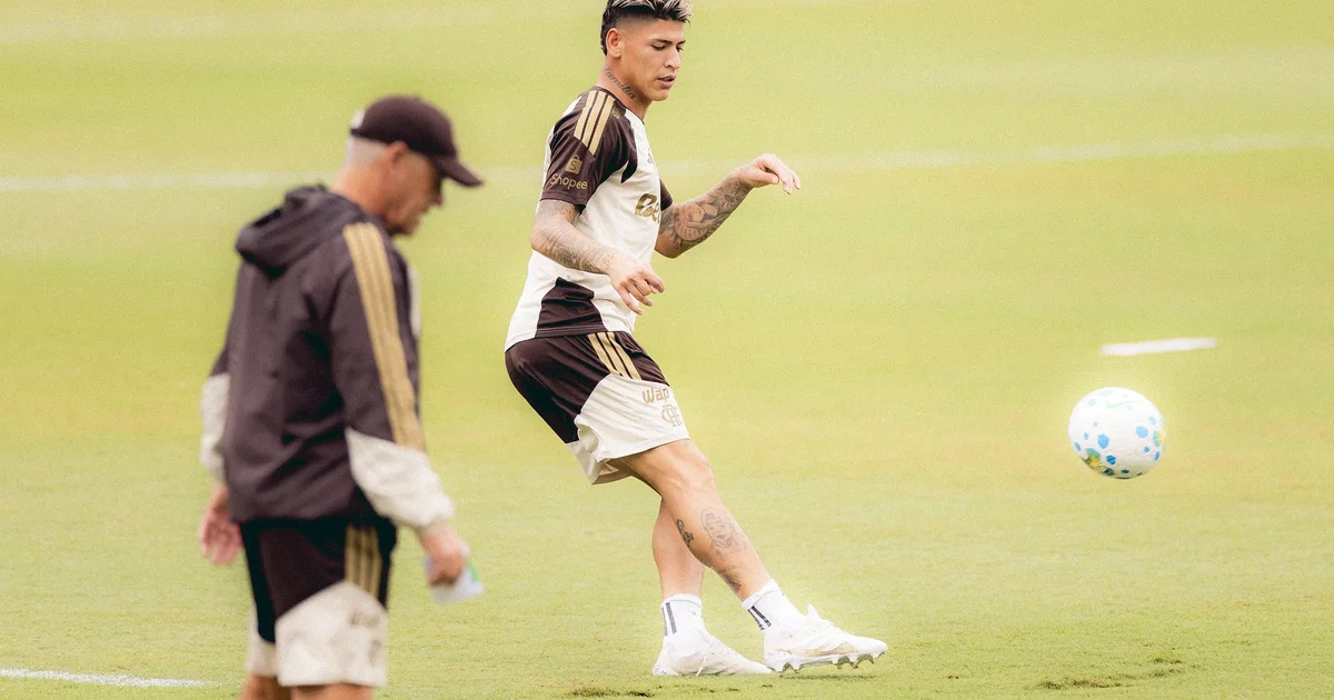 Meia retorna e treina no Ninho do Urubu, silhueta em uniforme rubro-negro, estádio ao fundo, clima de preparação para o jogo