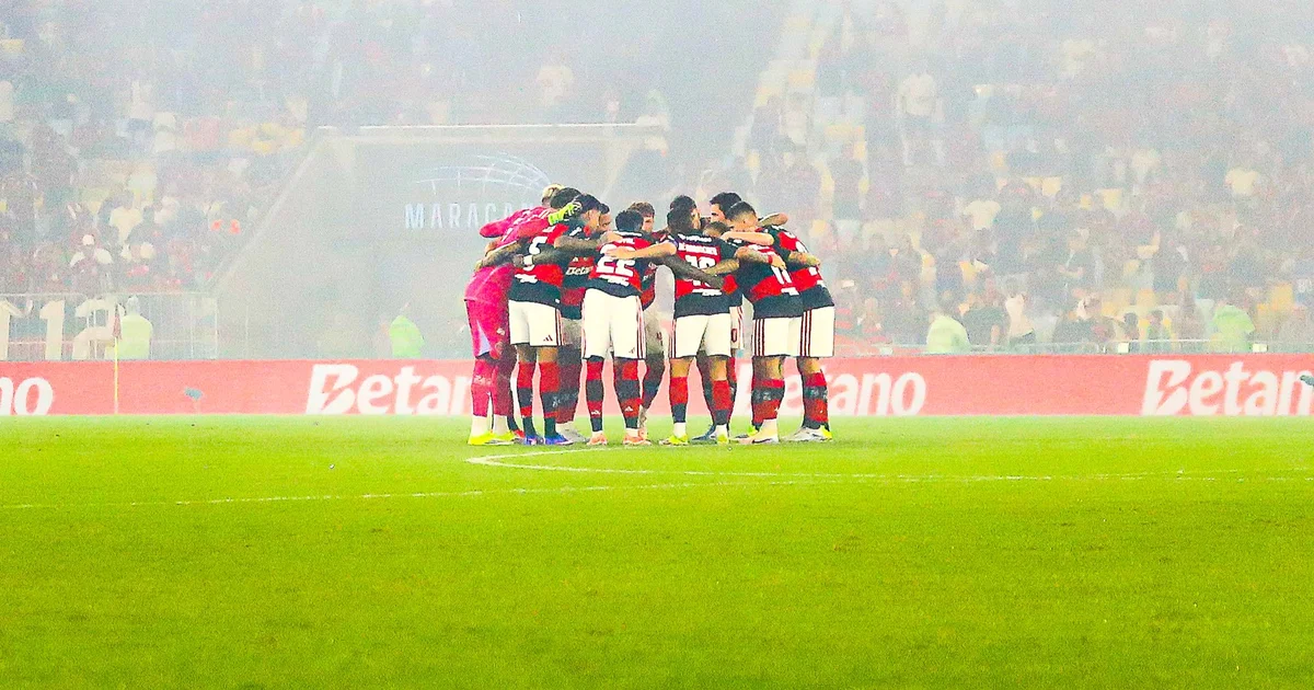 Ilustração editorial: três jogadores de uniforme vermelho e preto representam Flamengo em celebração pela convocação à seleção brasileira em estádio iluminado.